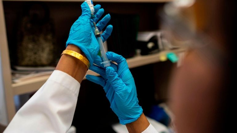 A nurse prepares the measles, mumps and rubella vaccine in 2019. The quarantine, which began...