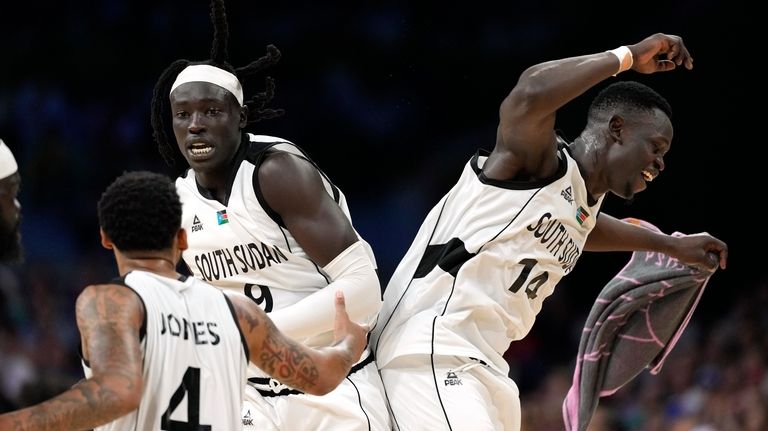 Carlik Jones, left, of South Sudan, Wenyen Gabriel, center, of...