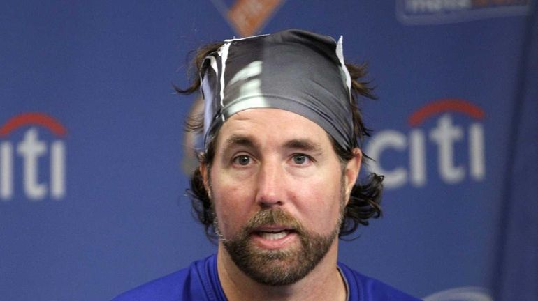 Mets pitcher R.A. Dickey responds to questions during a news...