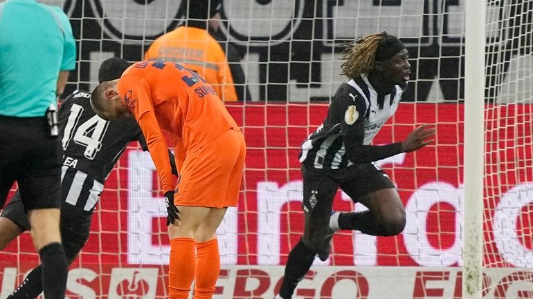 Moenchengladbach's Manu Kone celebrates after scoring the winning goal during...