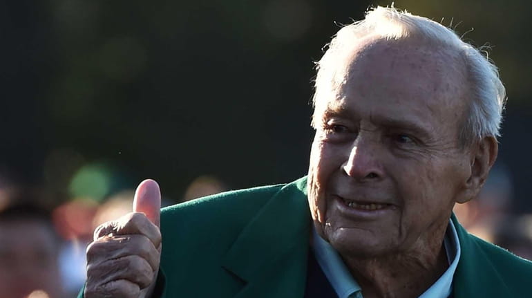 Honorary starter Arnold Palmer greets fans as he arrives to...