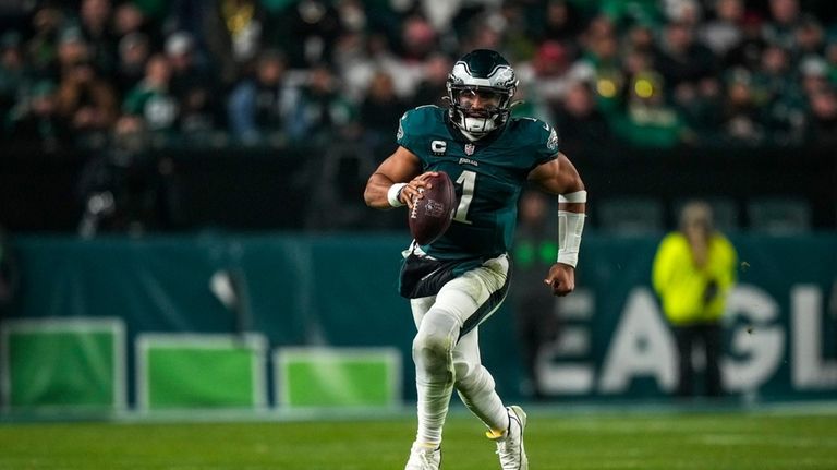 Philadelphia Eagles quarterback Jalen Hurts runs for yardage against the...