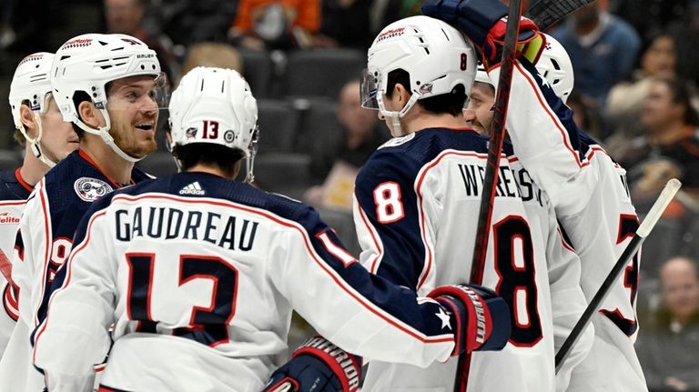 Columbus Blue Jackets center Jack Roslovic, second from left, celebrates...