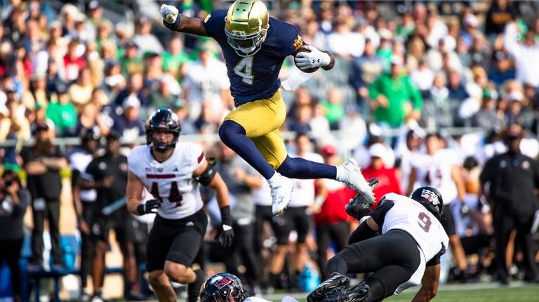 Notre Dame running back Jeremiyah Love (4) leaps over Northern...