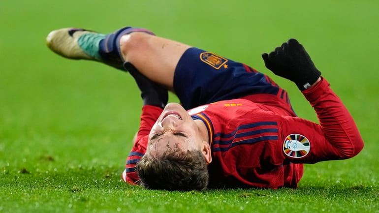 Spain's Gavi Paez reacts after injuring his leg during the...
