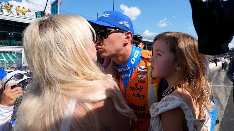Graham Rahal is greeted by his family after qualifying for...