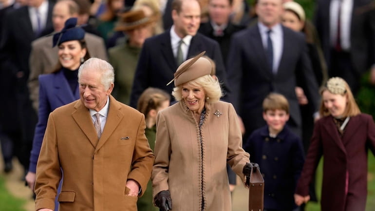 Britain's King Charles III and Queen Camilla arrive to attend...