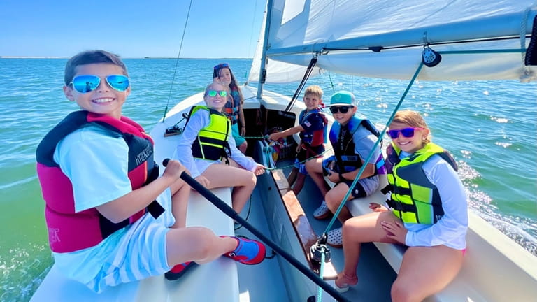 Moriches Island Sailing students and cousins (clockwise from left) Chuck...