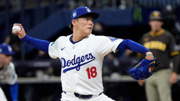 Los Angeles Dodgers starting pitcher Yoshinobu Yamamoto throws to the...