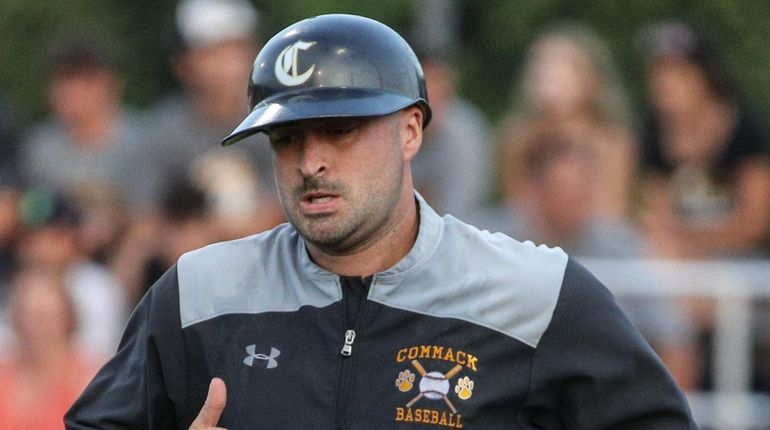 Commack coach Bryan Bonin jogs over to third during the...