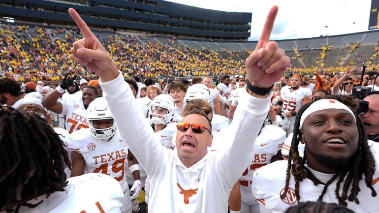 Texas head coach Steve Sarkisian celebrates after in beating Michigan...