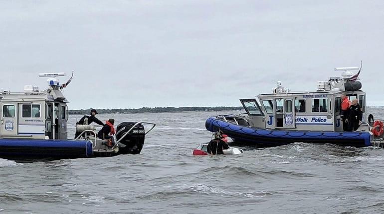 Suffolk Marine Bureau officers rescue four people from a sinking...