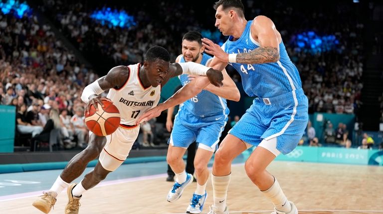 Germany's Dennis Schroder, left, tries to drive by Greece's Kostas...