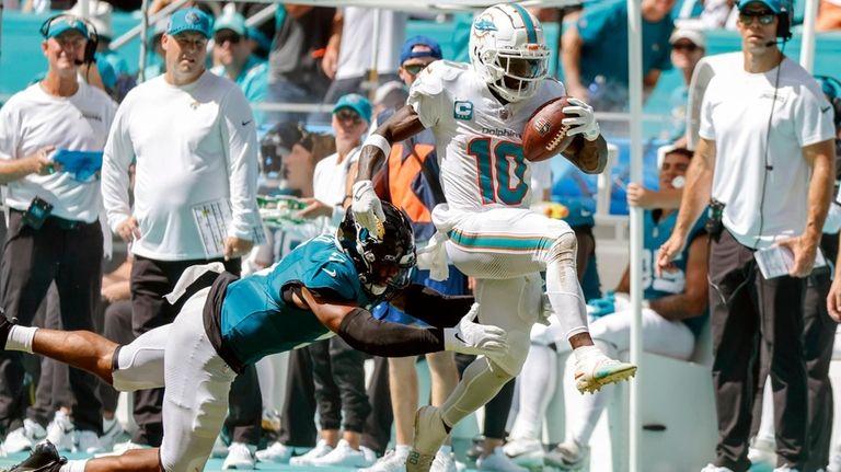 Miami Dolphins wide receiver Tyreek Hill (10) breaks a tackle...