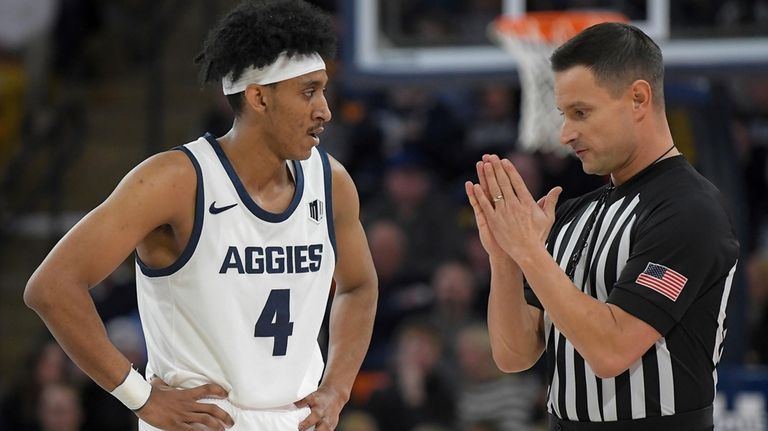 Utah State guard Ian Martinez (4) talks to a referee...