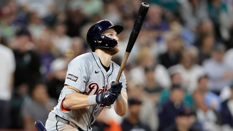 Detroit Tigers' Parker Meadows watches the flight of his ball...