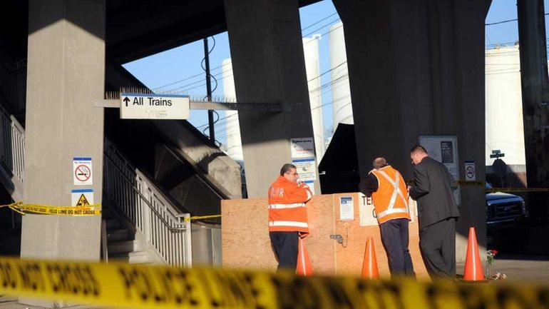 MTA officials look over an escalator at the LIRR station...