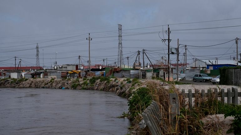 Water flows through Khayelitsha, Cape Town, South Africa, Thursday July...