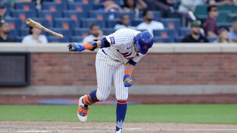 Jeff McNeil #1 of the Mets throws his bat after...