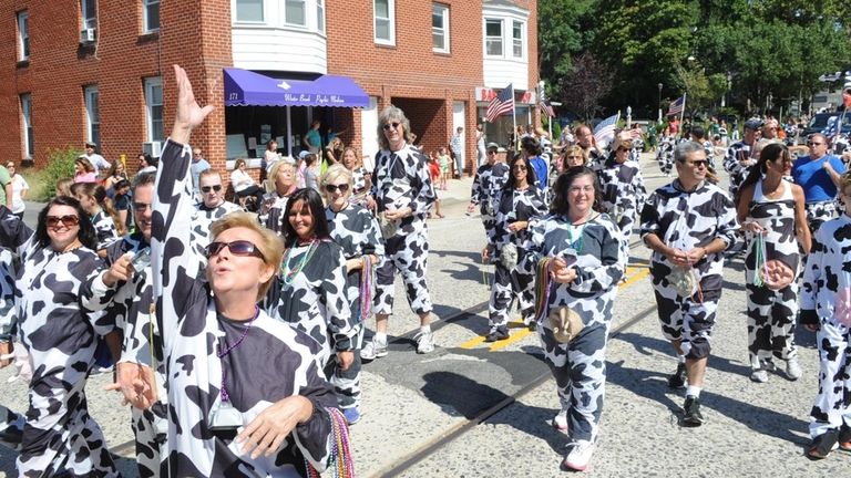 Marchers participate in the annual Cow Harbor Day parade on...