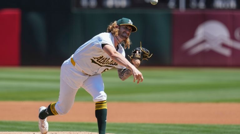 Oakland Athletics pitcher Joey Estes throws to a Milwaukee Brewers...