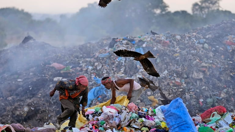 Waste pickers Salmaa and Usmaan Shekh, right, search for recyclable...