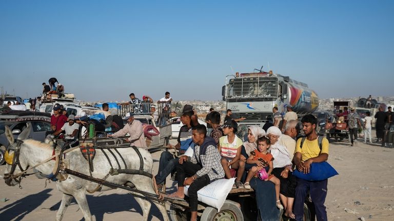 Palestinians flee the Khan Younis area of the Gaza Strip,...