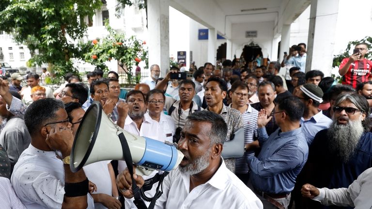 Lawyers protest as they gather in the court premises demanding...