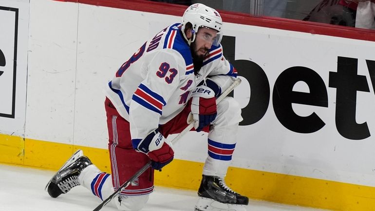 New York Rangers center Mika Zibanejad kneels on the ice...