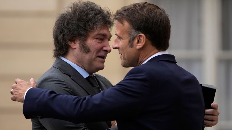 French President Emmanuel Macron, right, hugs Argentina's President Javier Milei...