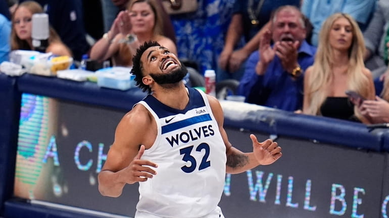 Minnesota Timberwolves center Karl-Anthony Towns (32) reacts to a play...