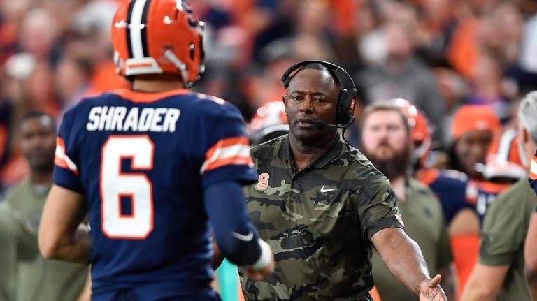 Syracuse head coach Dino Babers, right, congratulates quarterback Garrett Shrader...