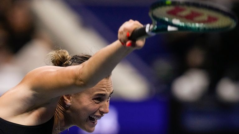 Aryna Sabalenka, of Belarus, serves to Emma Navarro, of the...