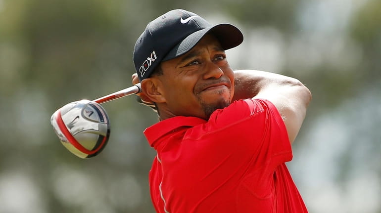 Tiger Woods hits his tee shot on the third hole...