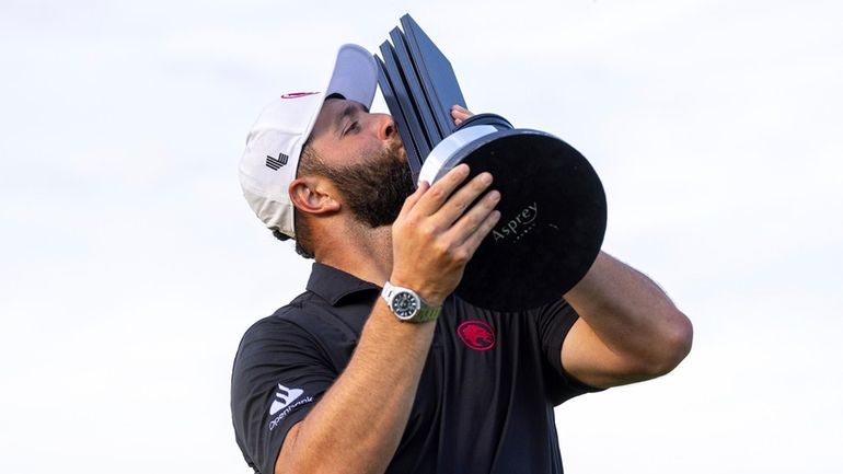 First-place champion, captain Jon Rahm, of Legion XIII, kisses the...