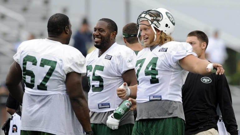 The Jets' offensive line, led by center Nick Mangold (74)...