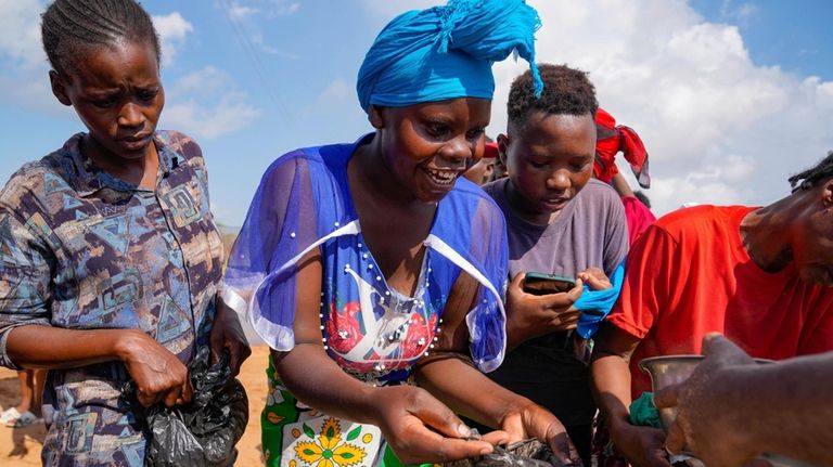 Residents receive relief food after El Niño rains damaged their...