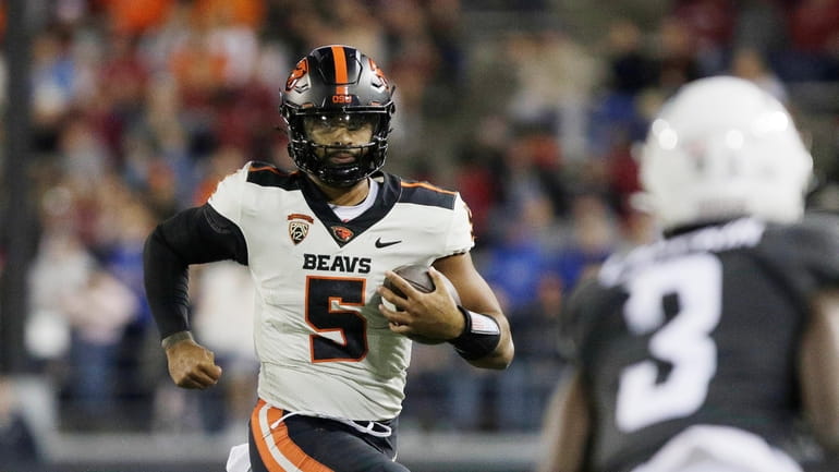 Oregon State quarterback DJ Uiagalelei (5) carries the ball during...