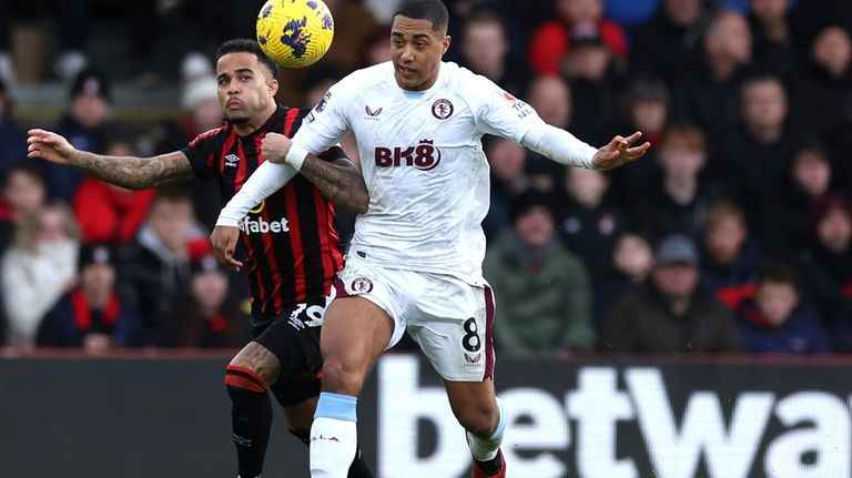 Bournemouth's Justin Kluivert, left and Aston Villa's Youri Tielemans vie...