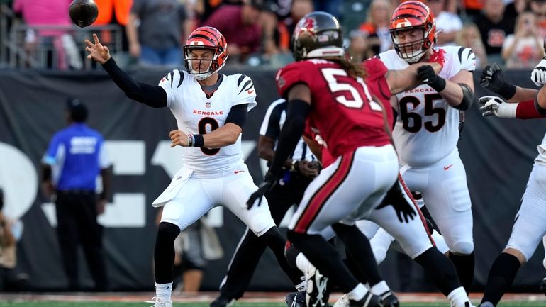 Cincinnati Bengals quarterback Joe Burrow (9) gets a pass away...