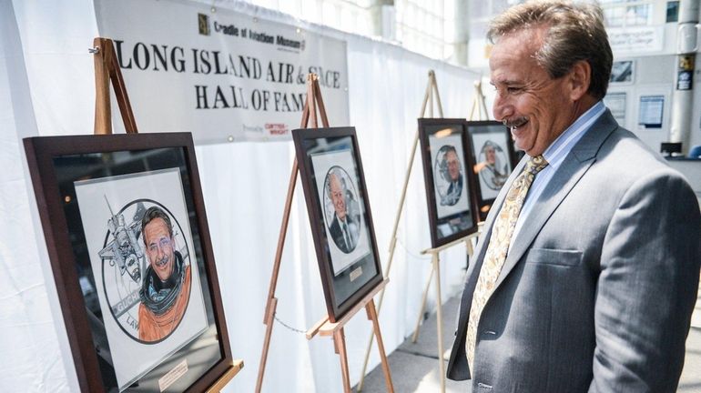 Space Shuttle Astronaut Charles Camarda views his painted portrait during...