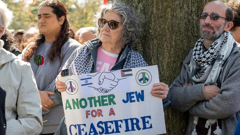 Rosalee Yelen of South Huntington holding a ceasefire poster at Long Island...