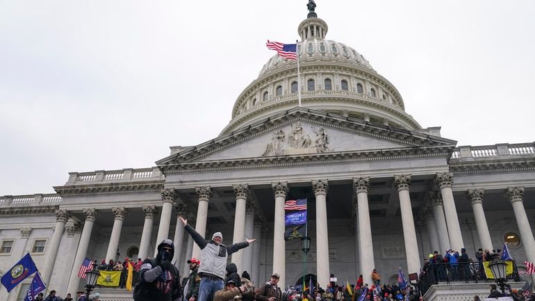 Rioters at the U.S. Capitol on Jan. 6, 2021, in...