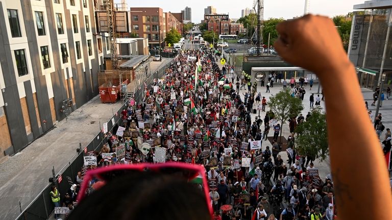 Protesters march during a demonstration outside the Democratic National Convention...