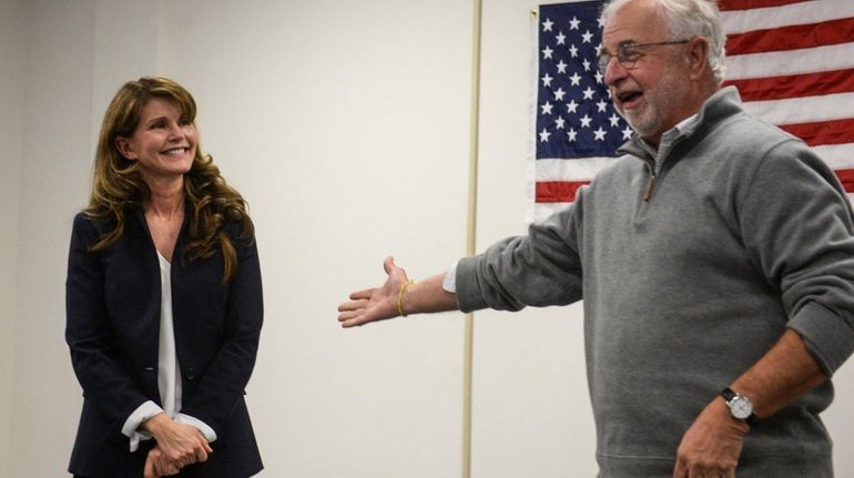 Anna Throne-Holst listens as former Rep. Tim Bishop speaks to...