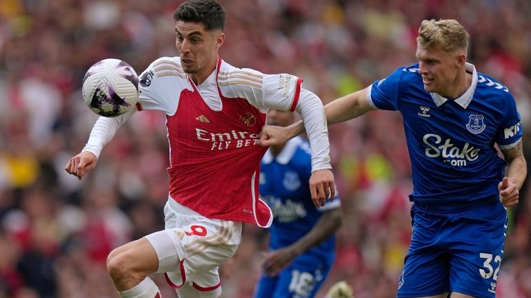 Arsenal's Kai Havertz, left, and Everton's Jarrad Branthwaite battle for...