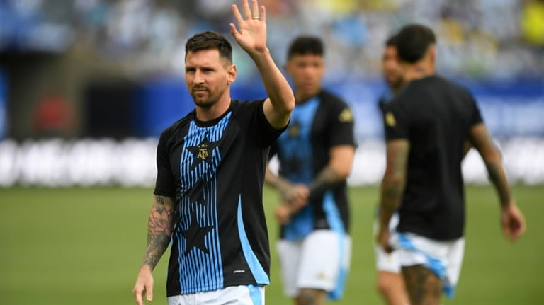 Argentina's Lionel Messi waves to the crowd before an international...