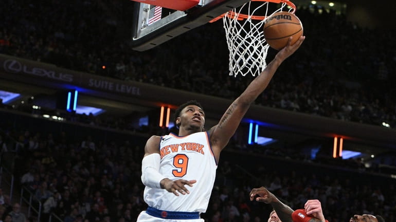 Knicks guard RJ Barrett puts up a layup against the...
