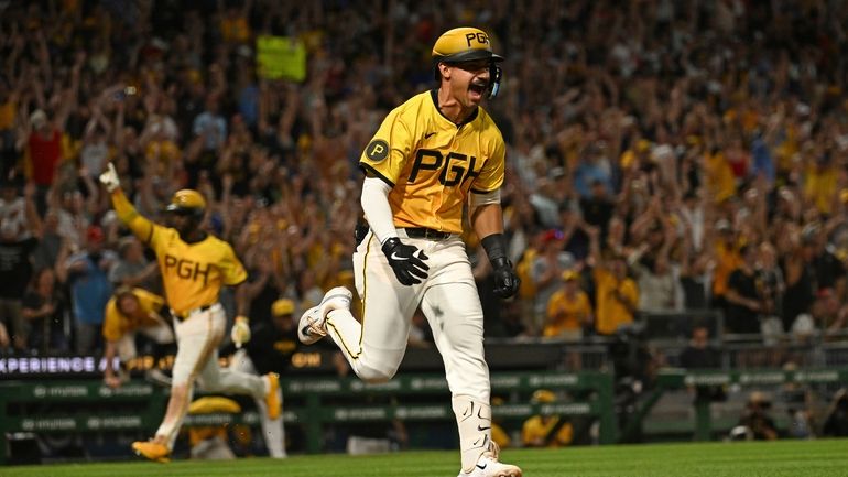 Pittsburgh Pirates' Nick Gonzales, right, reacts after hitting a walkoff...