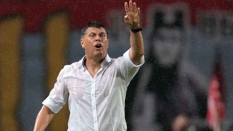 Red Star's head coach Vladan Milojevic shouts to his players...